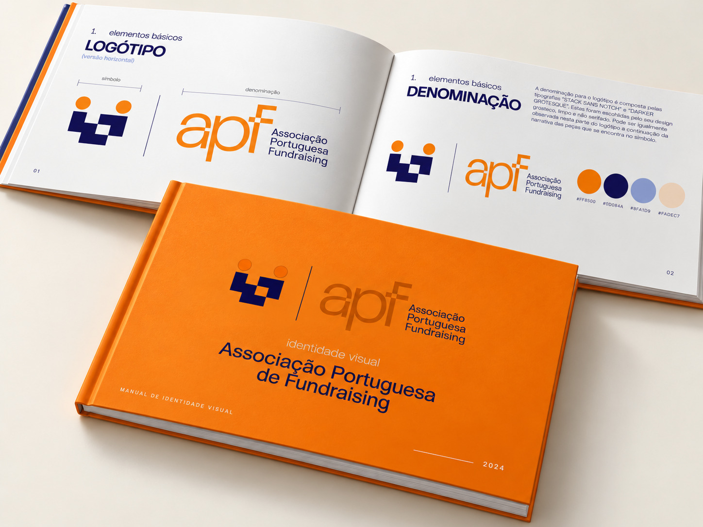 Manual de identidade visual da Associação Portuguesa de Fundraising apresentado num livro laranja